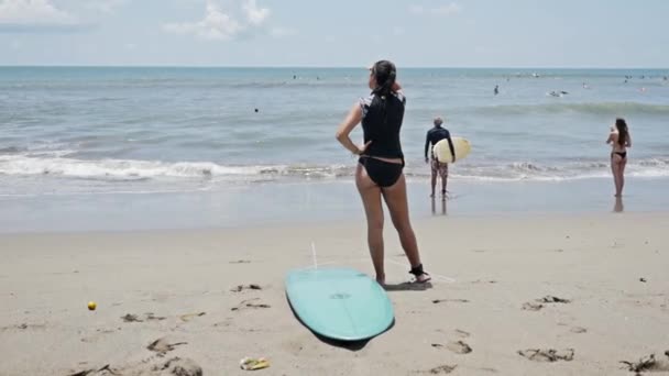Surfistas en la costa de playa en Indonesia — Vídeo de stock