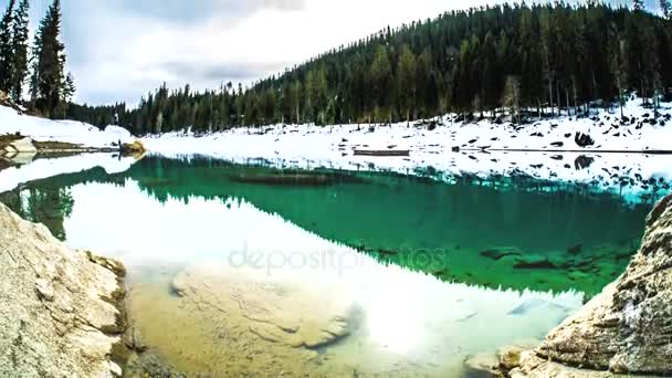 Timelapse de um lago, parcialmente coberto de neve . — Vídeo de Stock