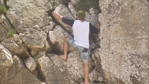 Junge klettert auf Felsen — Stockvideo