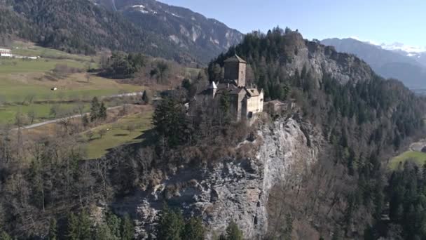 Castle on the cliff in a valley with mountains — Stock Video