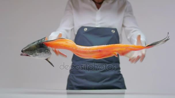 The cook throws a large fish with a brushed torso on the table. — Stock Video