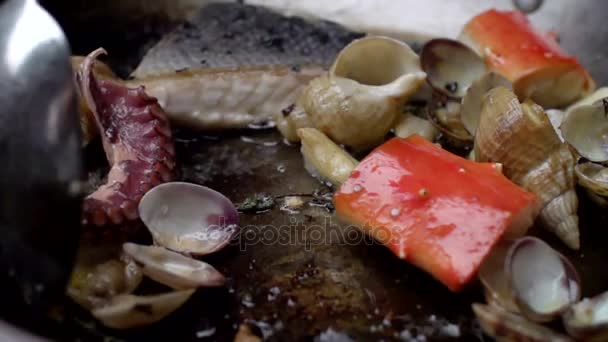 El marisco es mezclado con la cuchara durante la fritura en la cacerola . — Vídeos de Stock