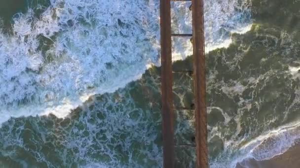 Top view of a wooden pier standing in the ocean. — Stock Video