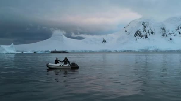 Dva lidé sedí v gumovém člunu v zálivu Antarktidy. Andreev. — Stock video