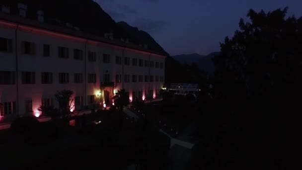 Byggnaden är upplyst av strålkastare på natten. — Stockvideo