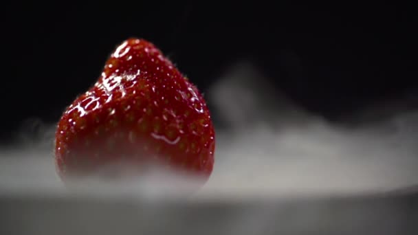 Fog from liquid nitrogen envelops the strawberry. — Stock Video