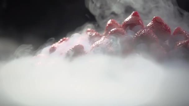 A pair of liquid nitrogen envelops the top of the pyramid of berries. — Stock Video