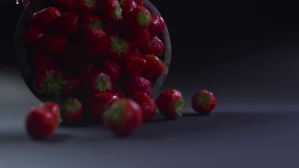Die ganze Erdbeere rollt aus der Schüssel an die Oberfläche. — Stockvideo