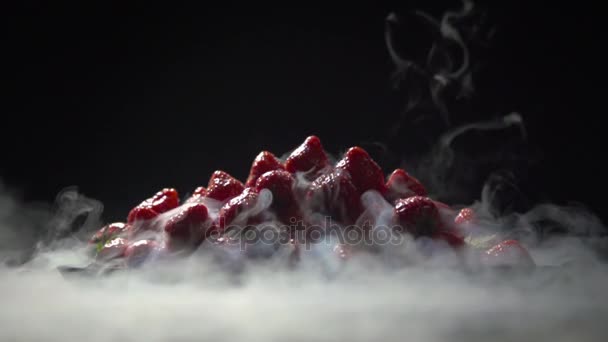 Pyramid of strawberries in liquid nitrogen. — Stock Video