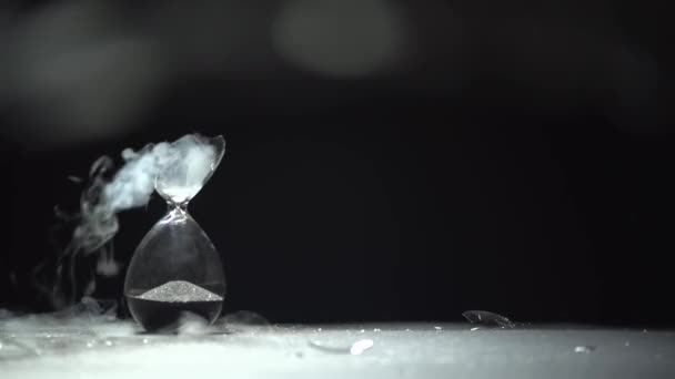 Liquid nitrogen drips onto the broken part of the hourglass. — Stock Video