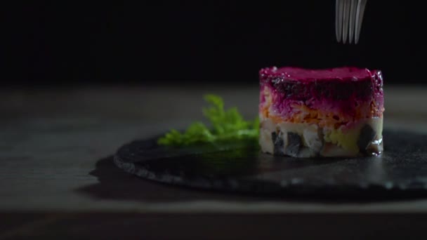 De vork liften langzaam een deel van de haring salade onder de bontjas. — Stockvideo