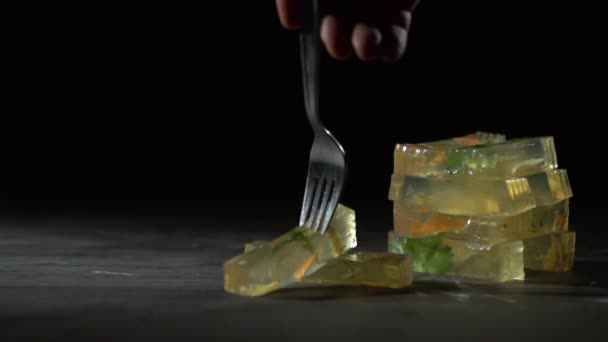 A fork pinches a piece of jelly slowly. — Stock Video