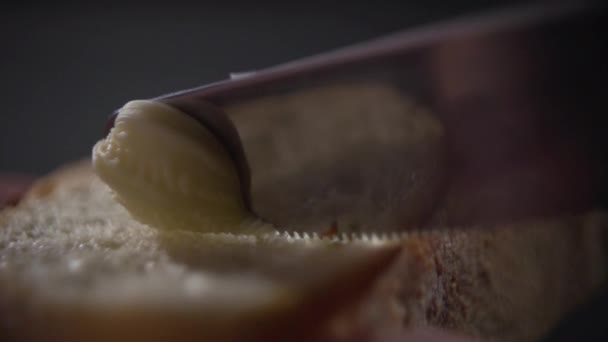 刀子的尖端在面包上涂抹黄油。. — 图库视频影像