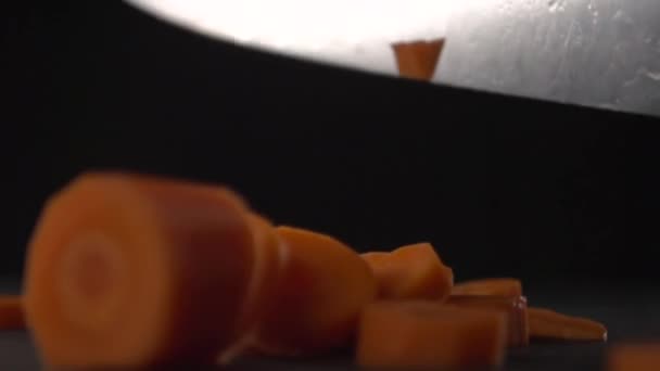 Ножевое лезвие вырезает кусочки моркови . — стоковое видео