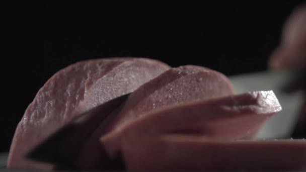 Ніж ножа розрізає ковбасу на шматки . — стокове відео