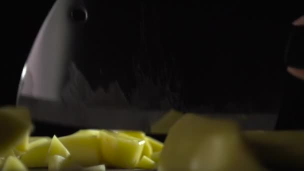 A sharp blade cuts raw potatoes into cubes. — Stock Video