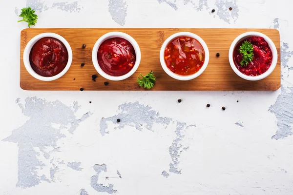 Bowls of various tomato sauces — Stock Photo, Image