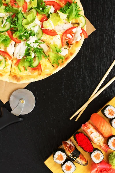 Sushi and pizza on stone