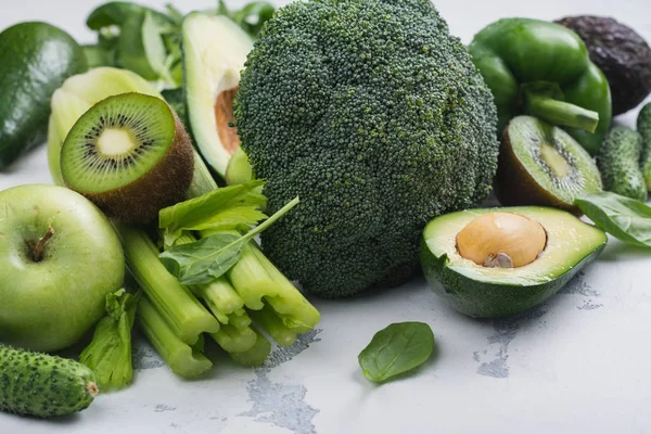 Green fruits and vegetables on white background