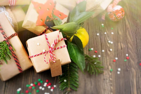 Many decorated Christmas presents on wooden background — Stock Photo, Image