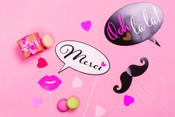 French theme photo props - lips, mustaches, gift box and macaroons on pink Valentines day background — Stock Photo, Image