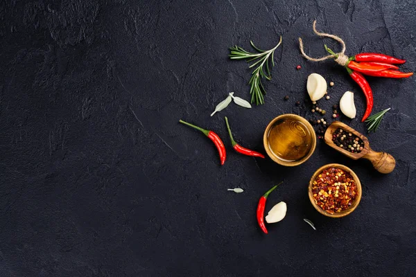Fresh herbs and spices on black stone table — Stock Photo, Image
