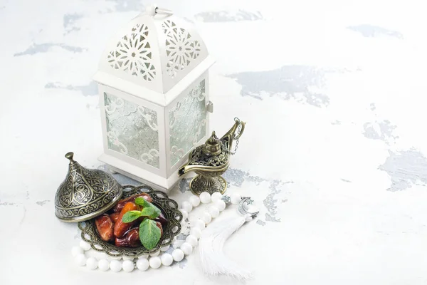 Arabic lantern, dates, aladdin lamp and rosary on white background — Stock Photo, Image