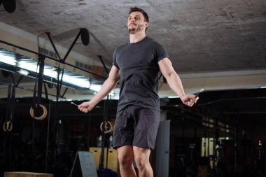 Oldukça genç adam jimnastik atlama ip atlama