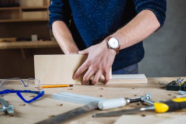 Young man working as carpenter  clipart