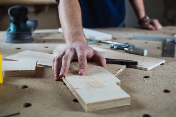 Young man working as carpenter 