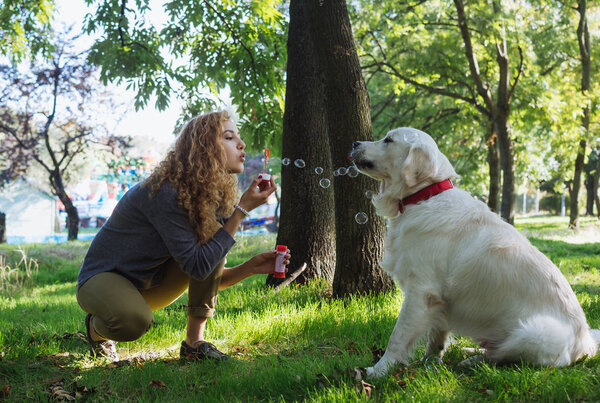   Young female playing with dog 