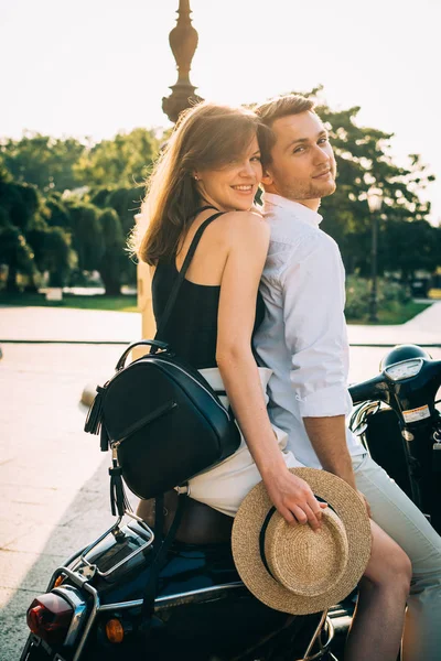 Couple in city with retro scooter