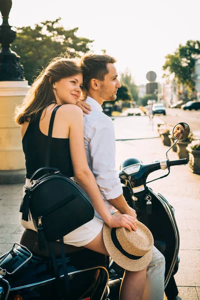 Couple in city with retro scooter