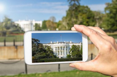 Photo of the White House on the Screen of a Smarthphone clipart