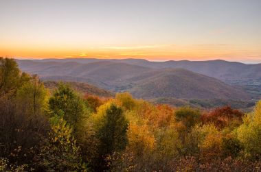 Sunset over a Beautiful Autumnal Mountain Landscape clipart
