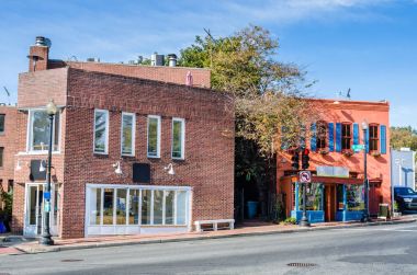 Güneşli bir sonbahar gününde bir tuğla kaldırım boyunca mağazaları Windows