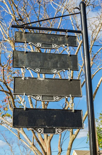 Old Fashioned Blank Metal Sign with a Bare Tree in Background on a Clear Autumn Day. Copy Space.