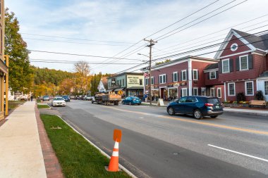 Stowe, VT - October 8, 2020: View of main street lined with traditional buildings and stores on a partly cloudy autumn day
