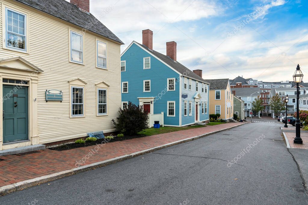 Traditional colourful New England detached houses along a deserted street at sunset. Portsmouth, NH, USA.