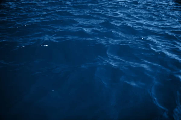 Surface ocean blue water background.
