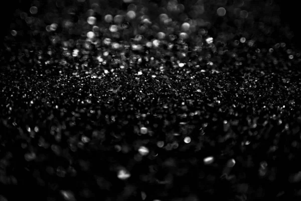 Glittering black and white bokeh background