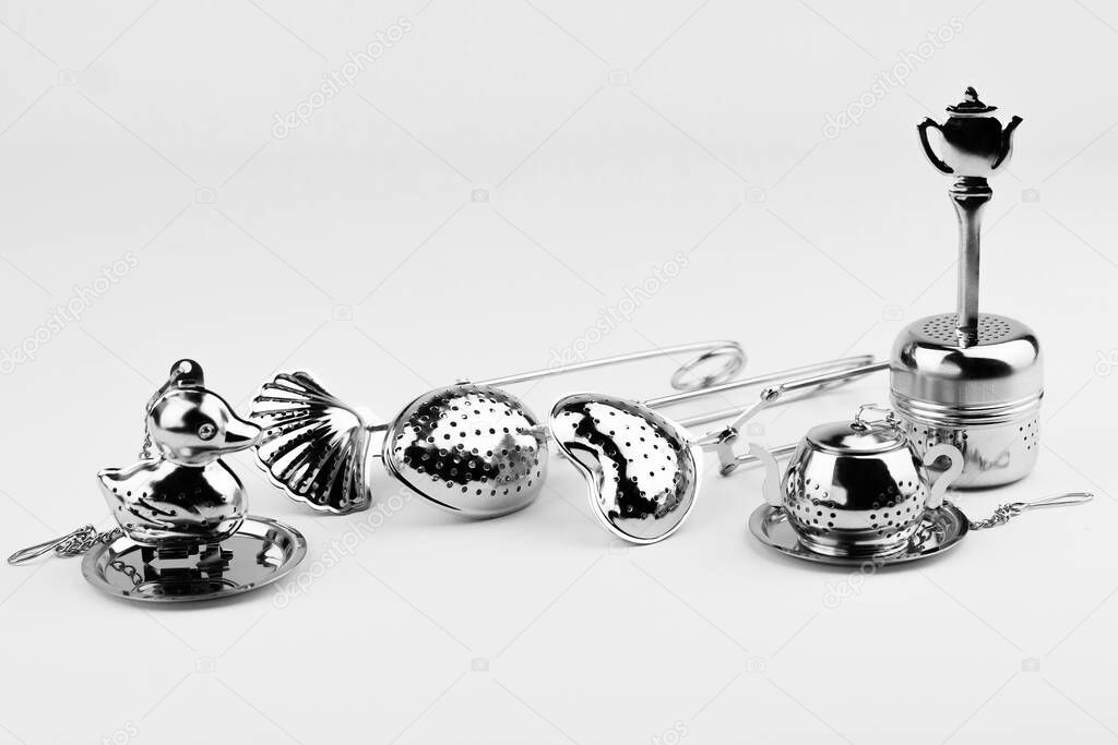 Different kinds of stainless tea strainers isolated on white background