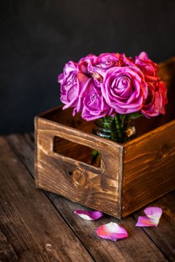 pink  roses in a wooden box clipart