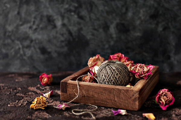 Dried roses and a ball of twine 