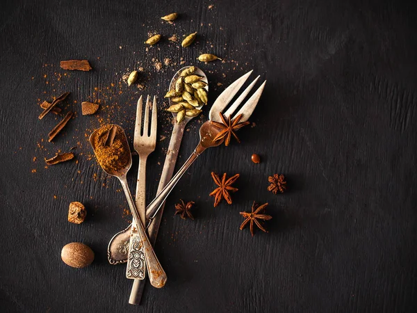 Spices and Cutlery on dark background — Stock Photo, Image