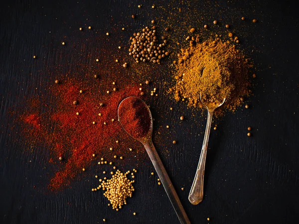 Paprika and curry in spoons — Stock Photo, Image