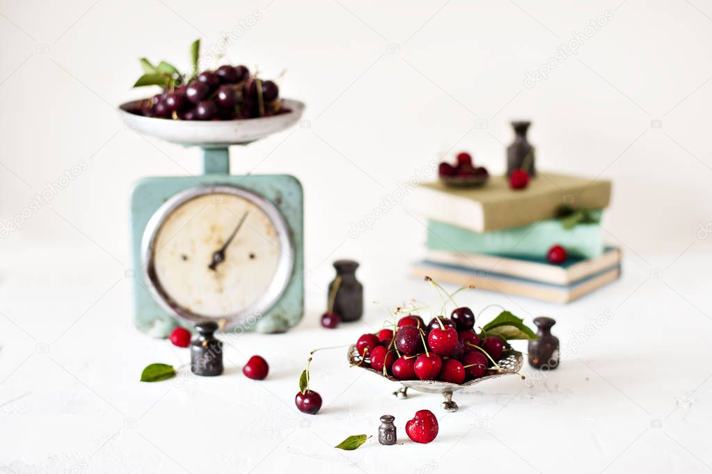 Old metalic scales with cherries