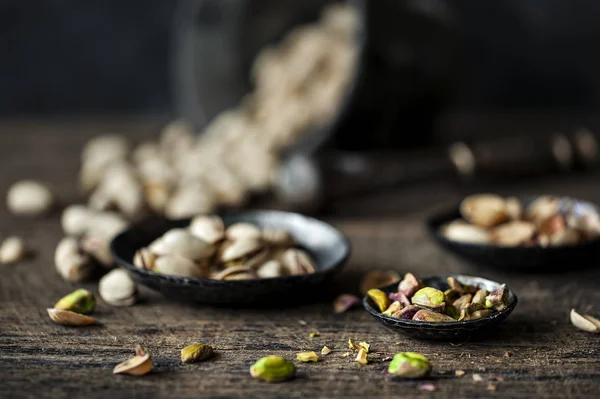 Dried pistachios in metal cups — Stock Photo, Image