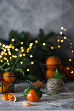 close-up photo of fresh oranges on concreted table with blurred Christmas lights on background  clipart