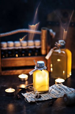 close-up photo of burning candles with two bottles and medical insurance on table background  clipart
